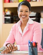 Smiling teacher in a classrom.